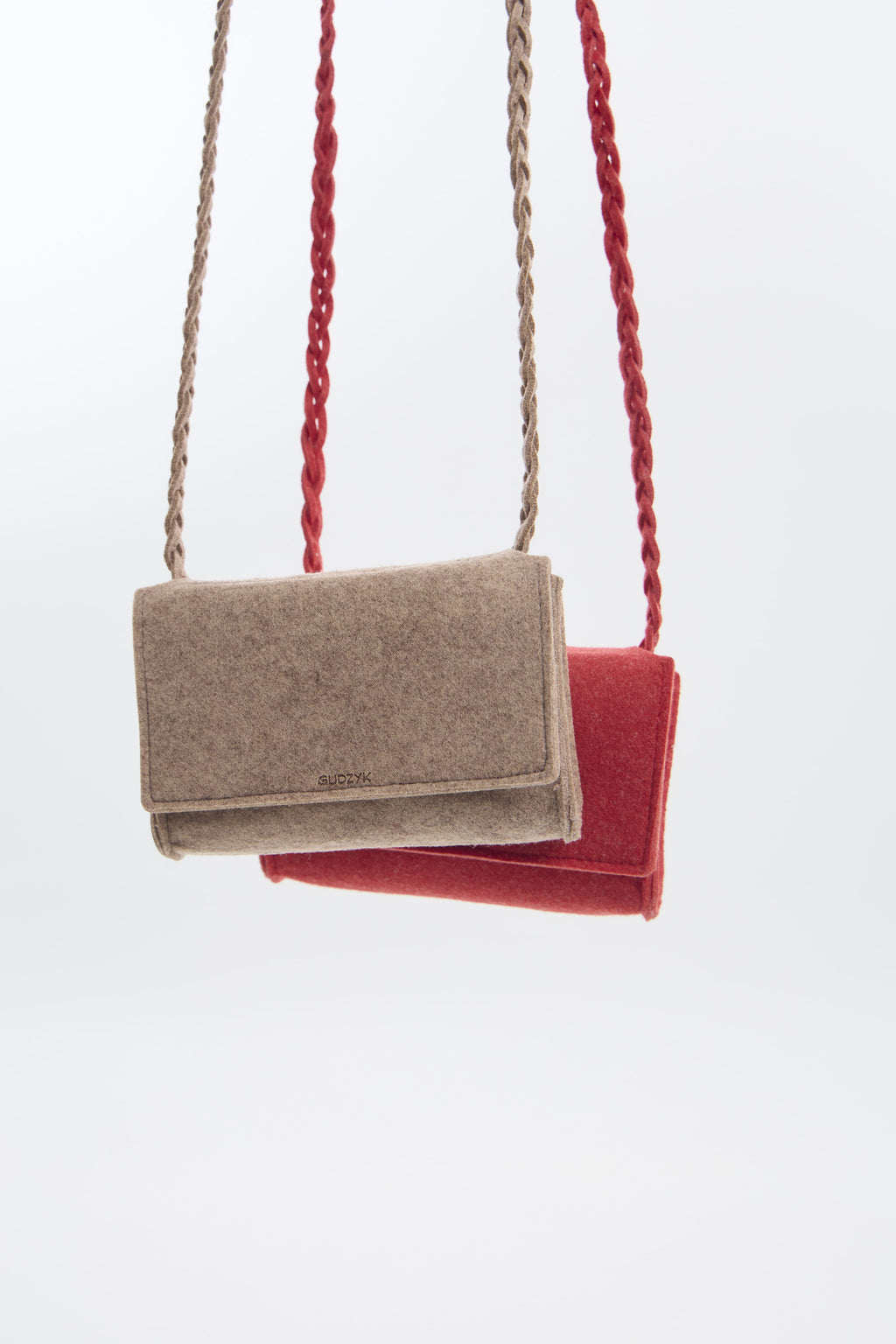 Beige and red felt mini crossbody bags with braided handles on a white background.