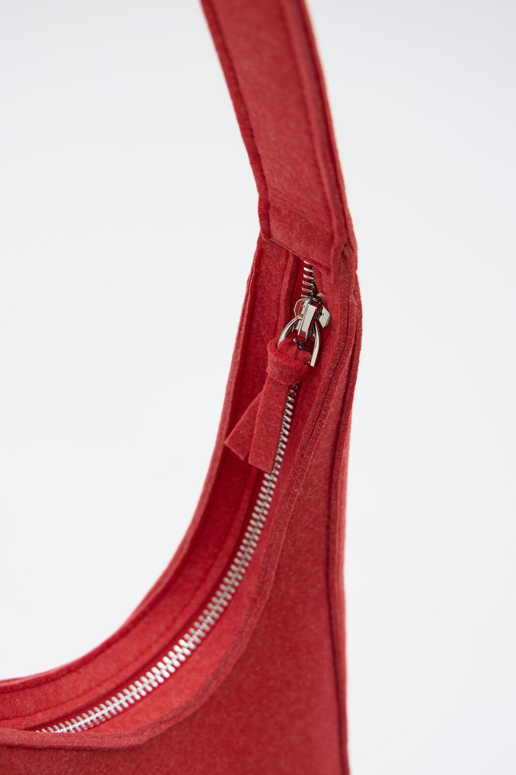 Close-up of a red zipper on a white background