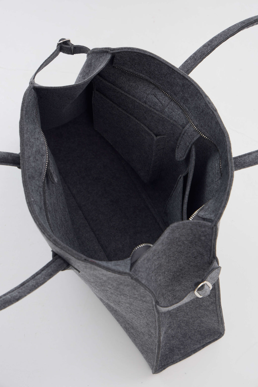 Gray backpack with a front pocket on a white background