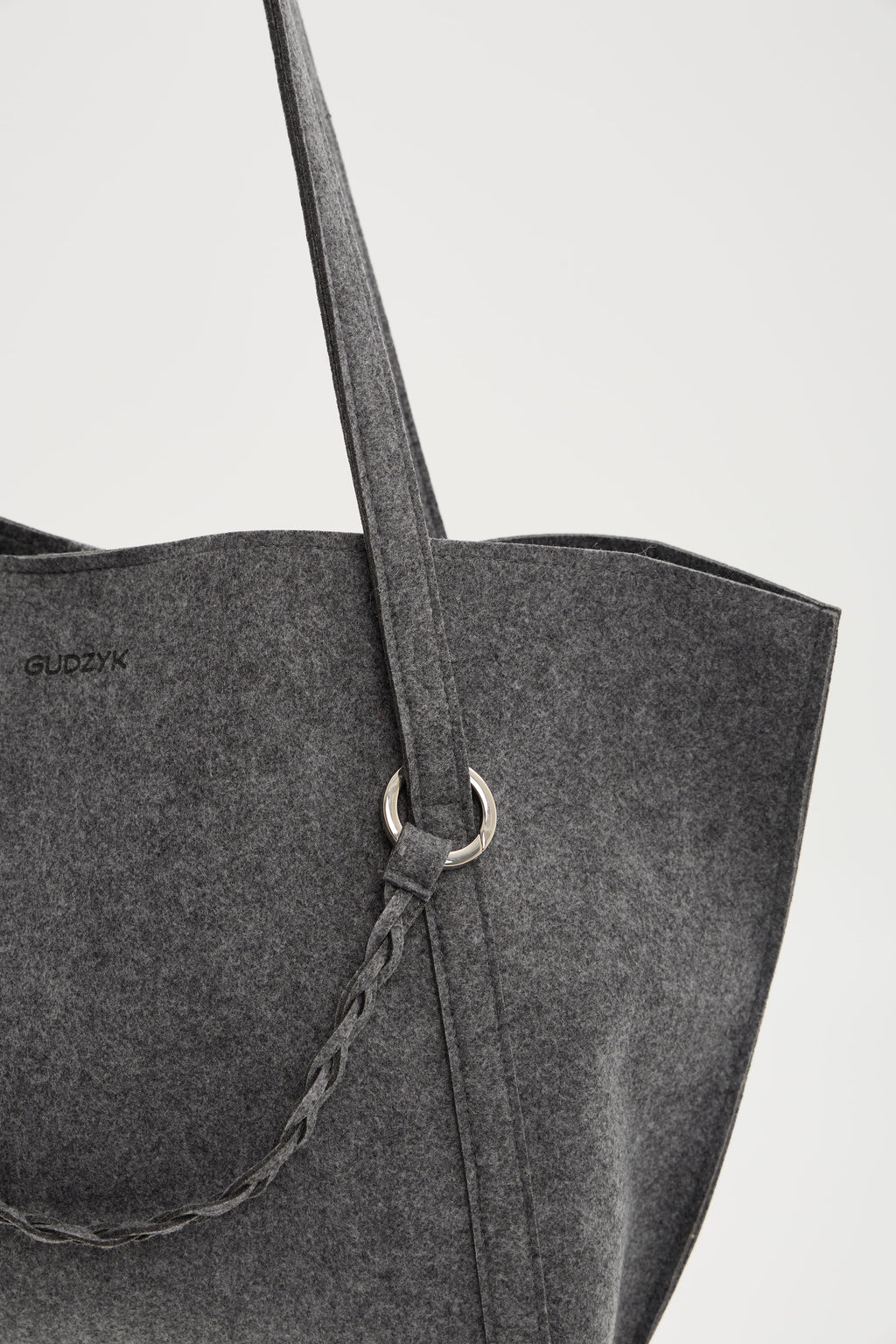 Gray tote bag with a strap on a light gray background