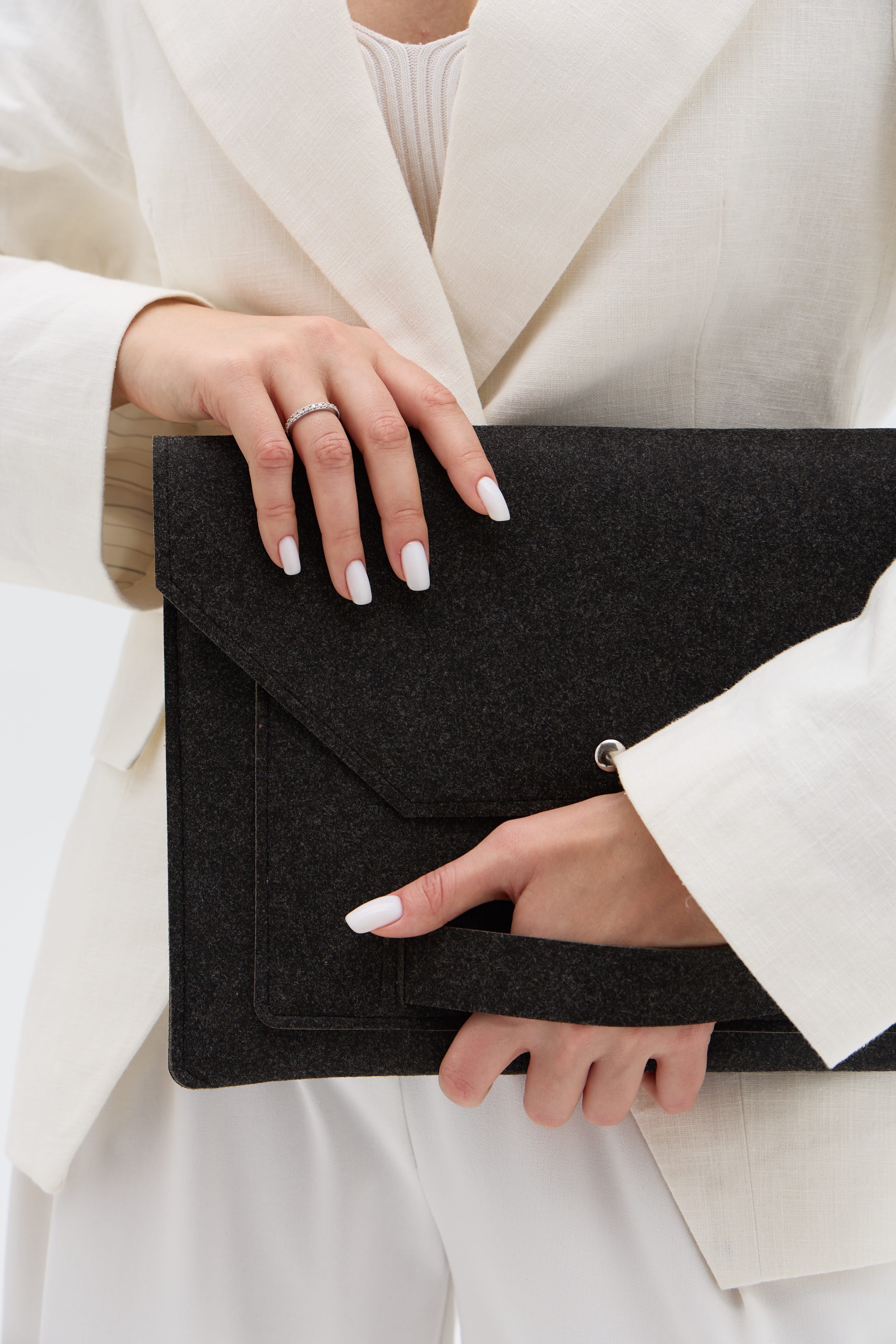 Person holding a black case with a white outfit