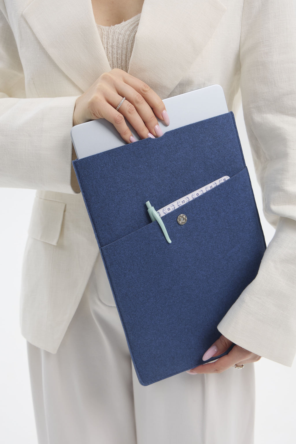 Person holding a blue laptop bag with a visible brand logo.