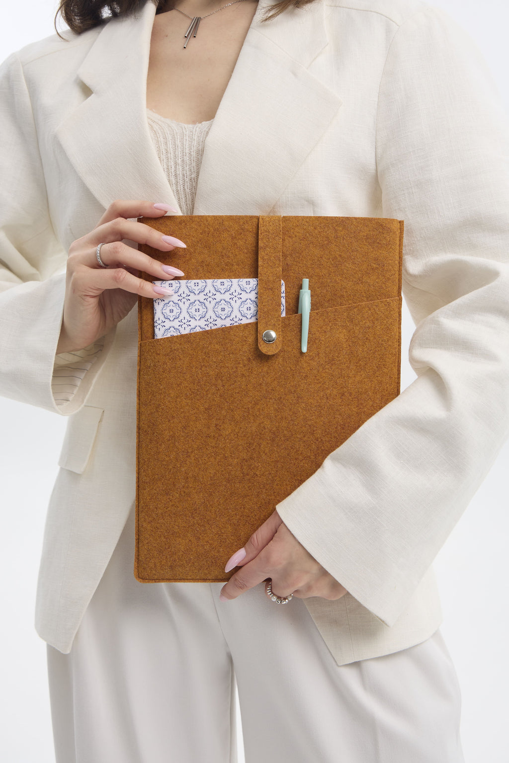 Person holding an orange felt case with a white background