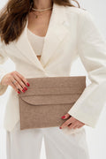 Woman holding a beige case against a white background