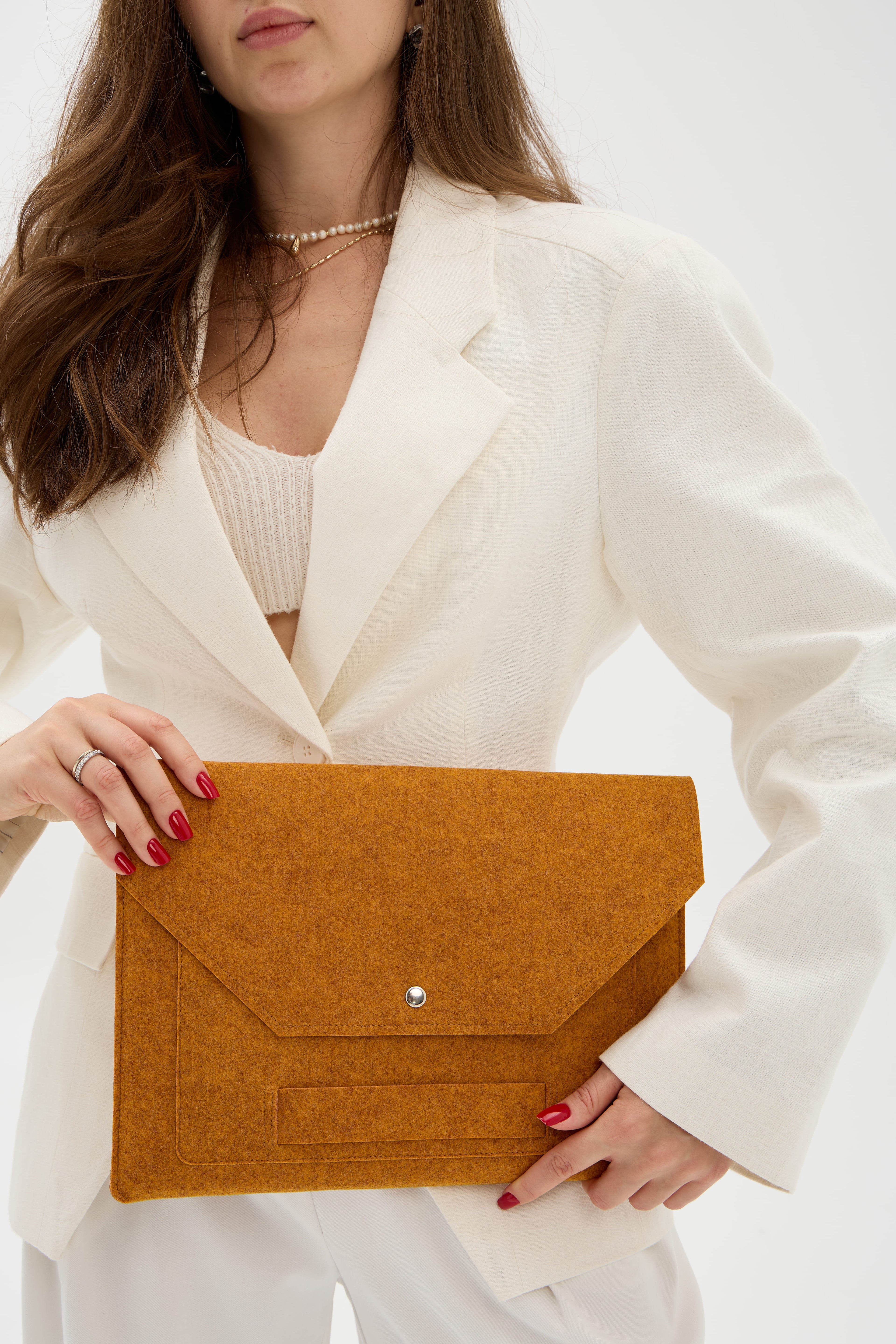 Woman holding an orange case against a white background