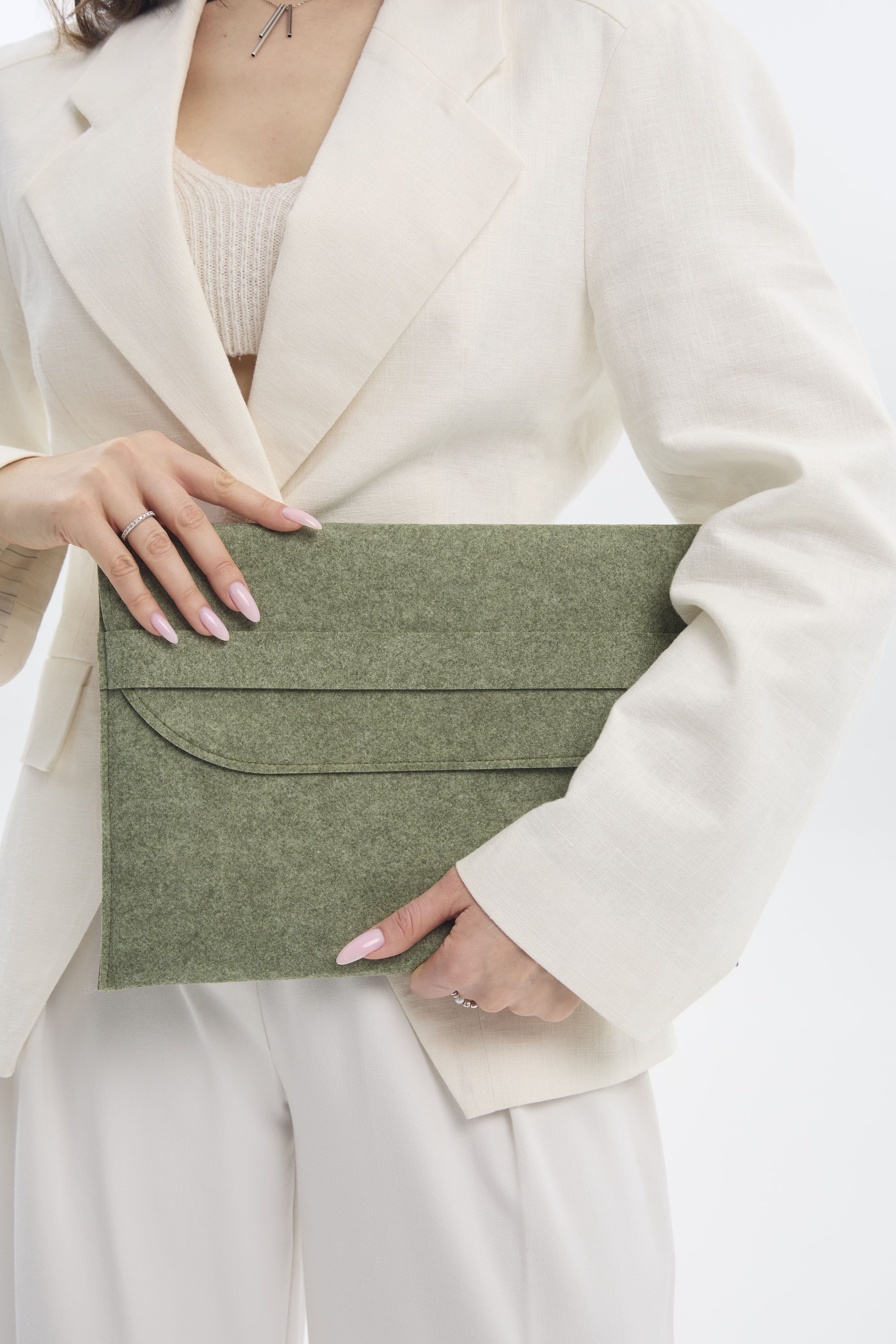 Person holding a green sleeve against a neutral background