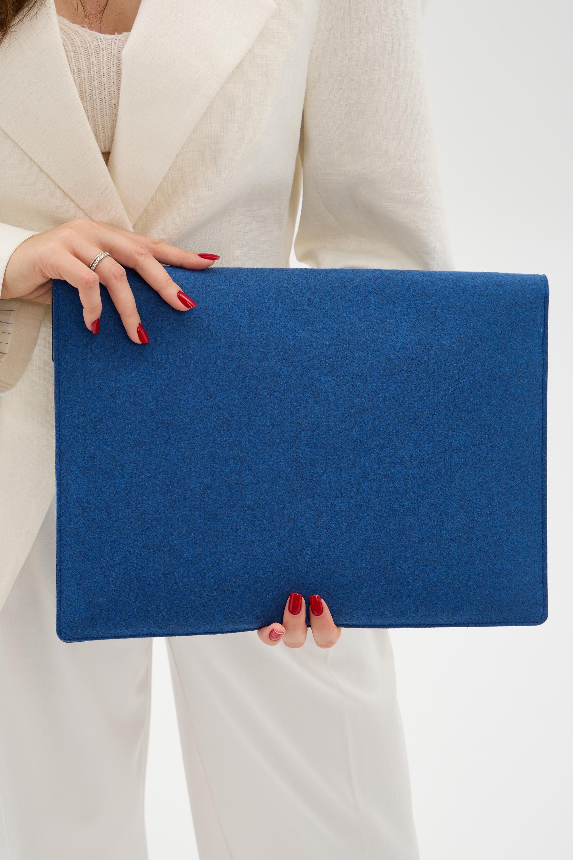 Person holding a blue case against a white background
